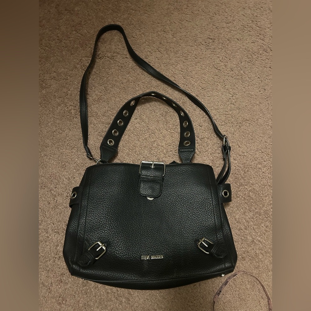 Steve Madden black pebbled buckle grommet crossbody bag.